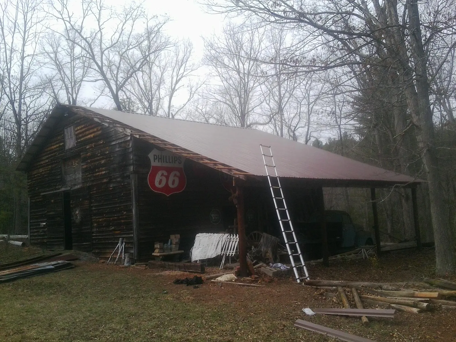 New metal roof on an open sided timber barn with a vintage sign in Port Penn